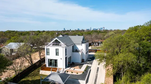 an aerial view of residential houses with outdoor space
