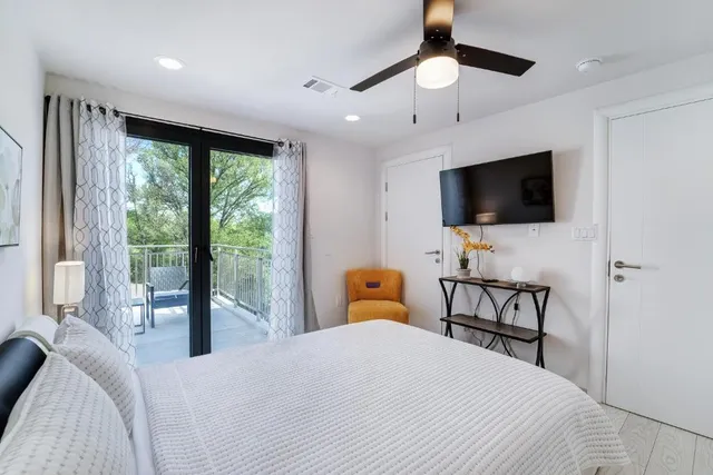 a bedroom with a bed and a chair