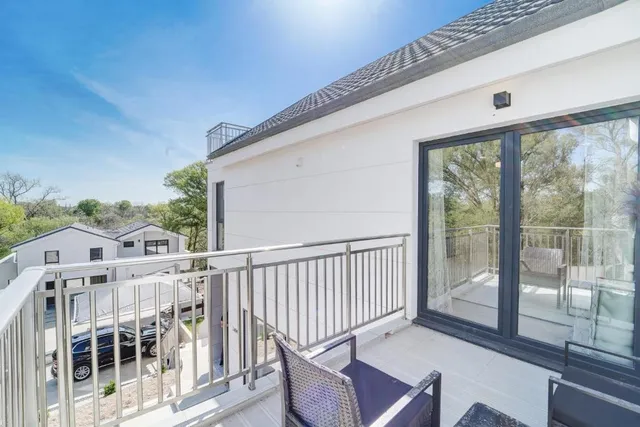 a view of a balcony with wooden floor
