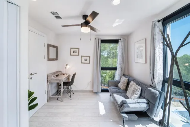 a living room with furniture and a large window