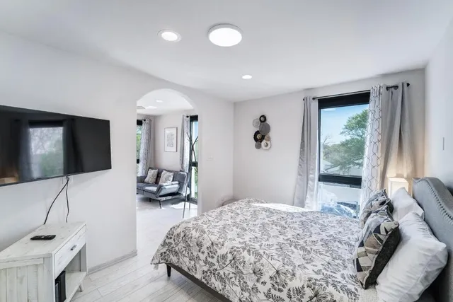 a bedroom with a bed and a flat screen tv