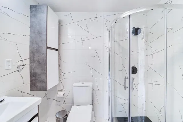 a bathroom with a toilet sink and mirror