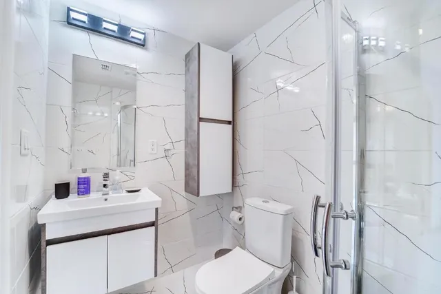 a bathroom with a toilet and shower