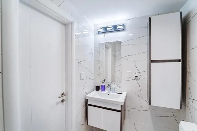 a bathroom with a sink toilet and shower