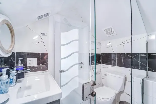 a bathroom with a sink toilet and shower