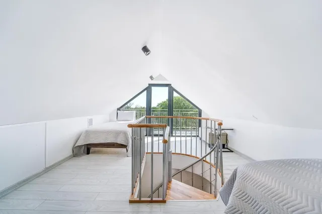 a bedroom with a bed and a view of balcony