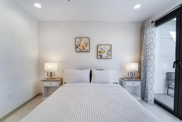 a bedroom with a bed and a night stand