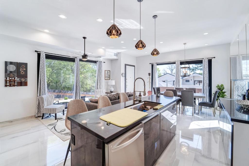 1409 East M. Franklin Avenue, Unit B Austin, TX 78721 - Photo 40 of 40 a kitchen with a stove a kitchen island a sink and living room view