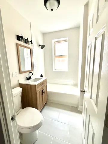 a bathroom with a sink a toilet and a mirror