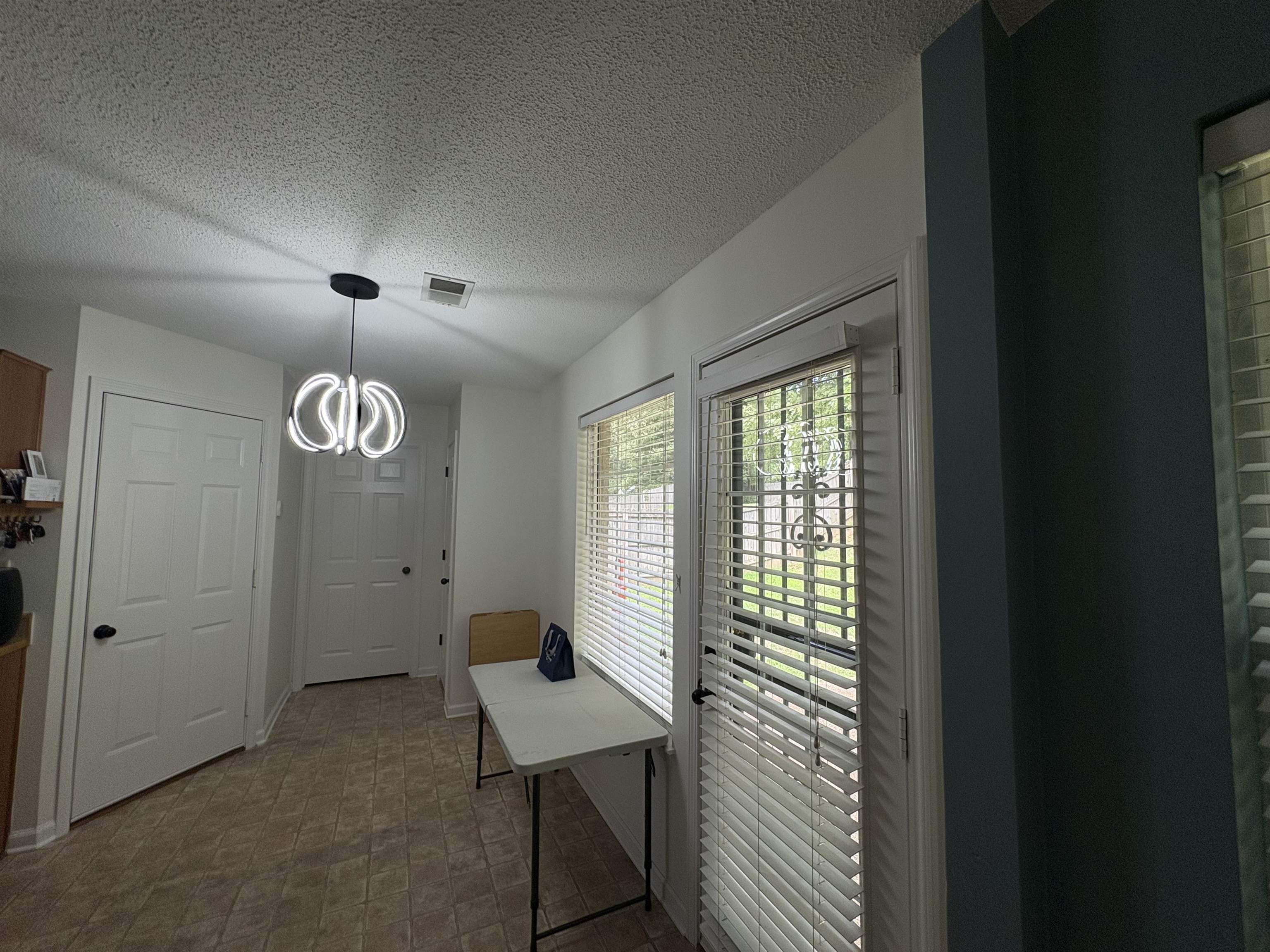 4356 Cedar Hills Road Memphis, TN 38135 - Photo 10 of 29 Entryway featuring a contemporary ceiling light fixture, two panel doors with black hardware, and tiled flooring