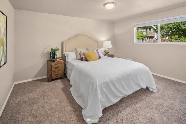 a bed sitting in a bedroom next to a window