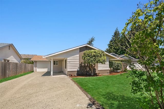 a view of a house with a yard and plants