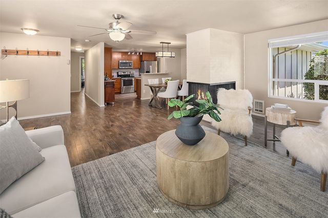 a living room with furniture flowerpot and a chandelier