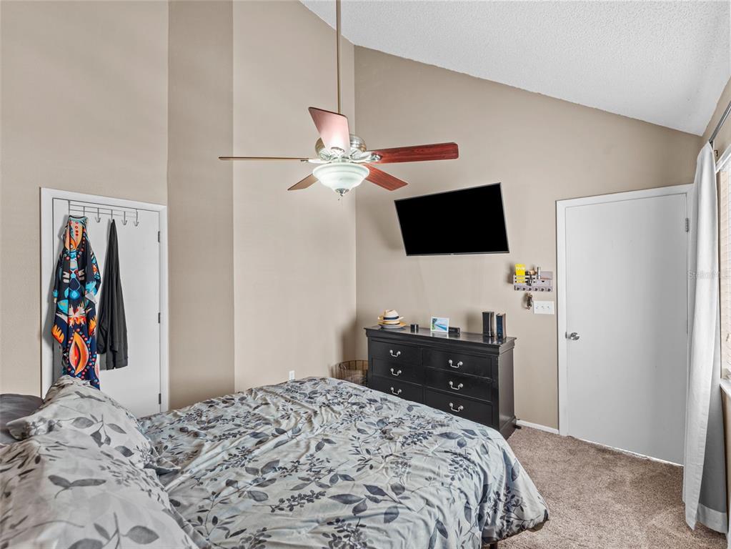 7705 Waterview Way, Unit 7705 Winter Haven, FL 33884 - Photo 16 of 33 a bedroom with a bed and a flat screen tv