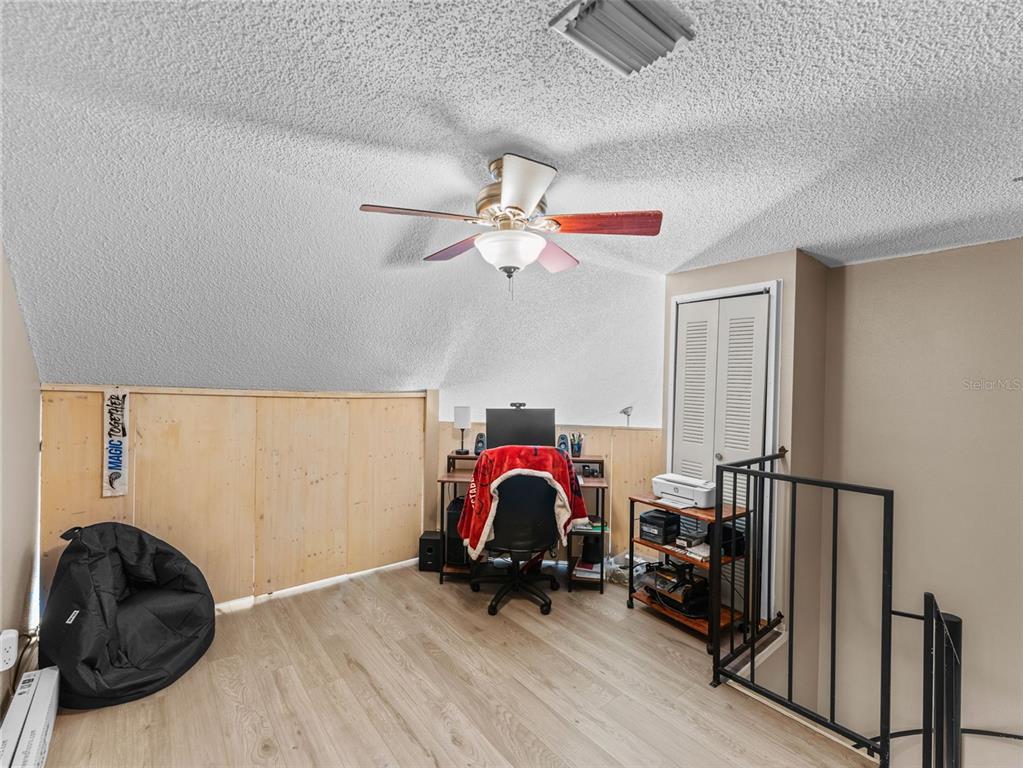 7705 Waterview Way, Unit 7705 Winter Haven, FL 33884 - Photo 18 of 33 a bedroom with a bed and a painting on the wall