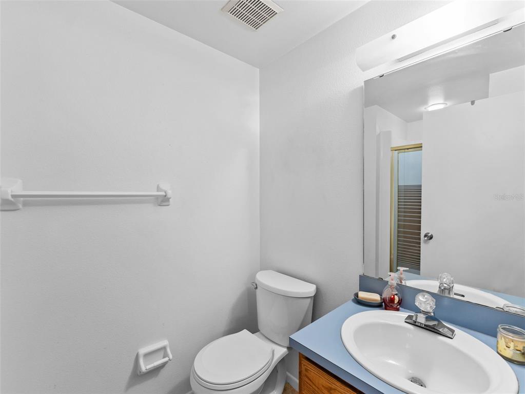 7705 Waterview Way, Unit 7705 Winter Haven, FL 33884 - Photo 20 of 33 a bathroom with a toilet a sink and mirror