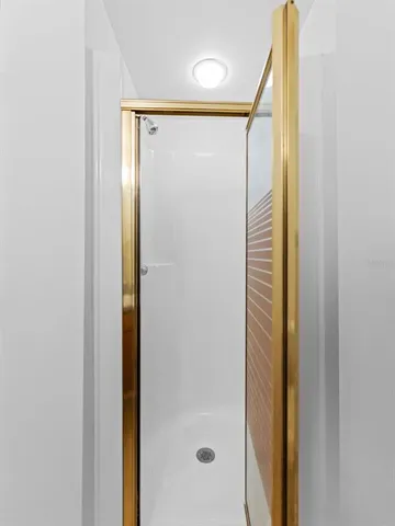 a bathroom with a glass shower door