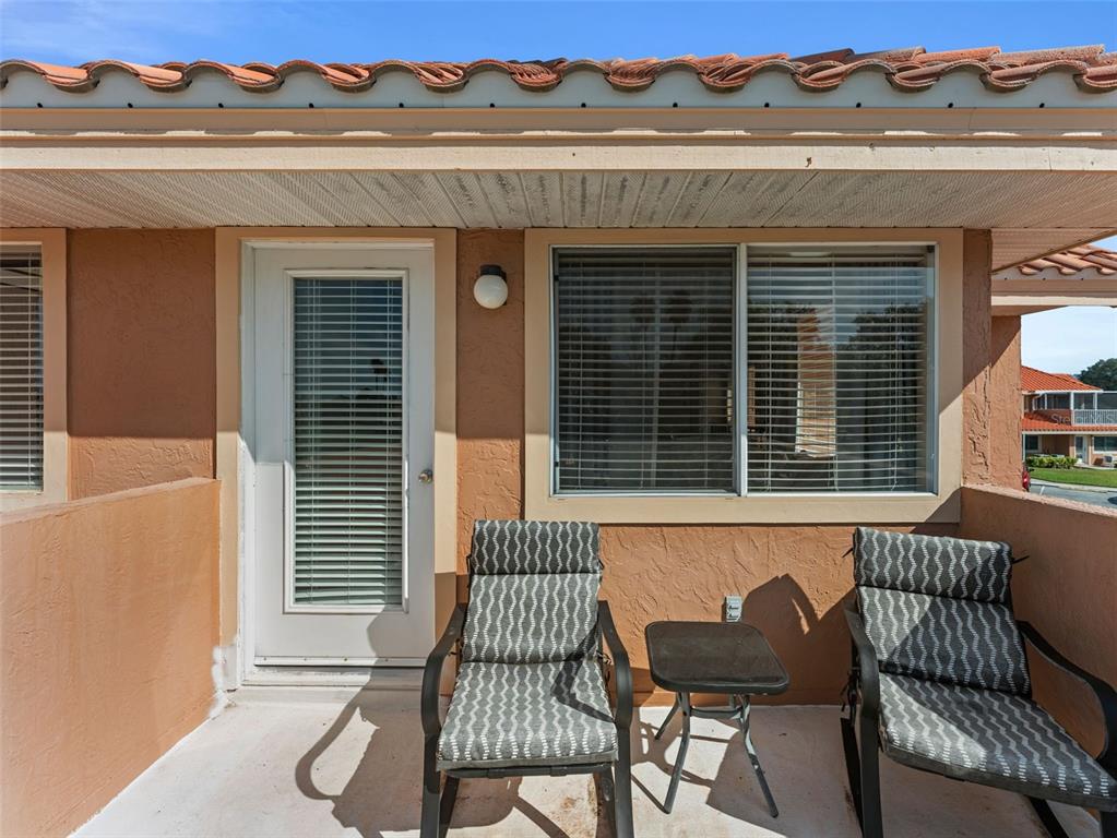 7705 Waterview Way, Unit 7705 Winter Haven, FL 33884 - Photo 26 of 33 a view of a chair and table in the back of a house
