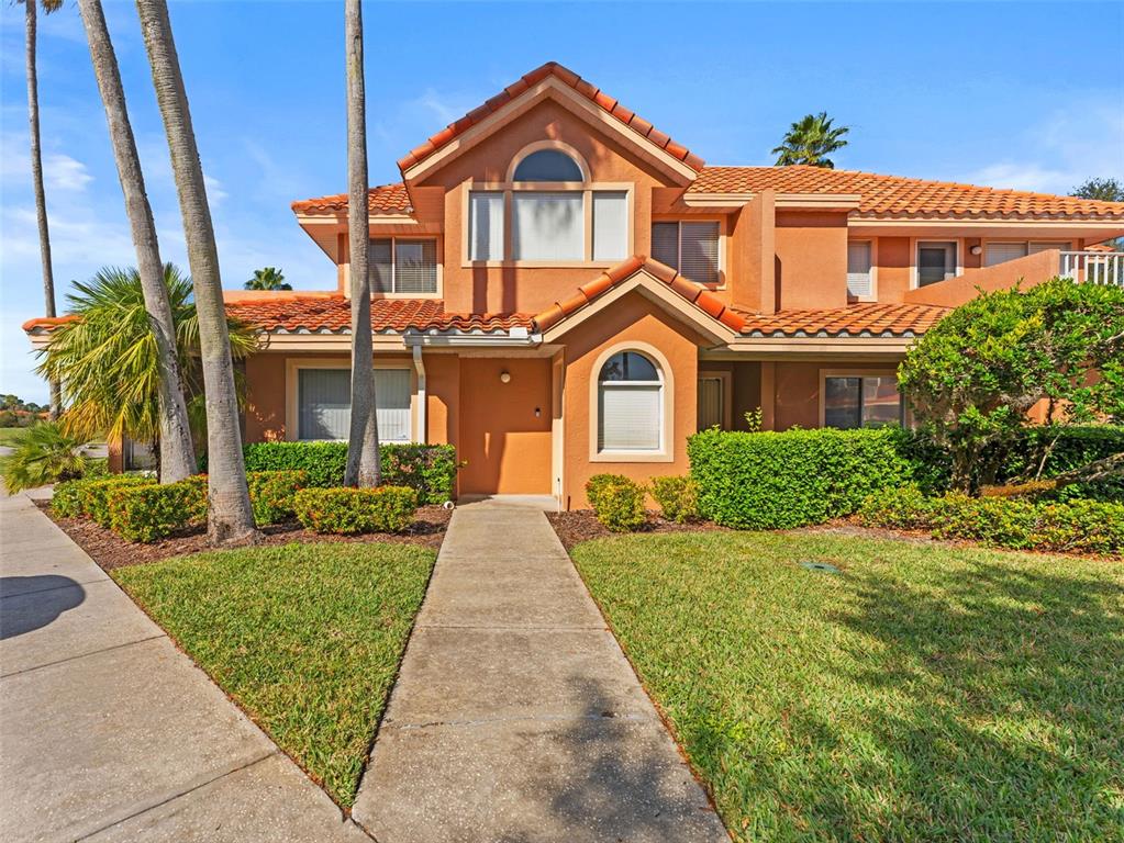 7705 Waterview Way, Unit 7705 Winter Haven, FL 33884 - Photo 3 of 33 a front view of a house with a yard