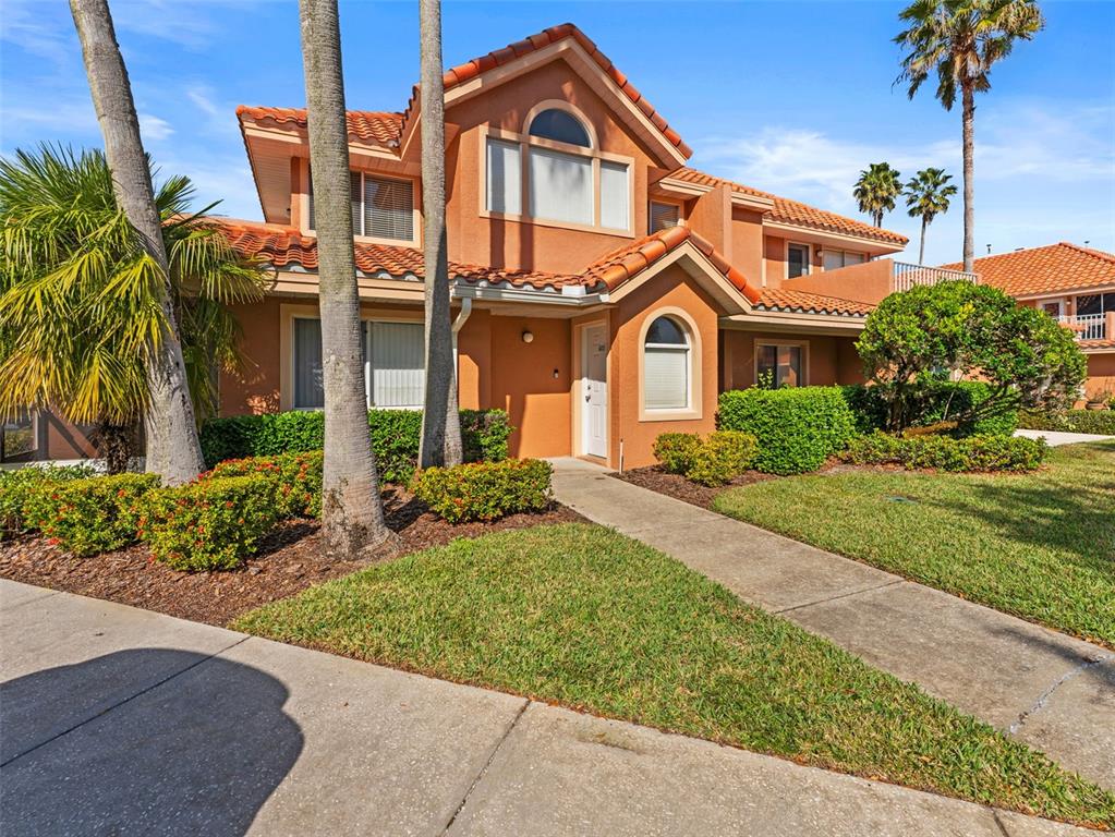 7705 Waterview Way, Unit 7705 Winter Haven, FL 33884 - Photo 4 of 33 a front view of a house with a garden