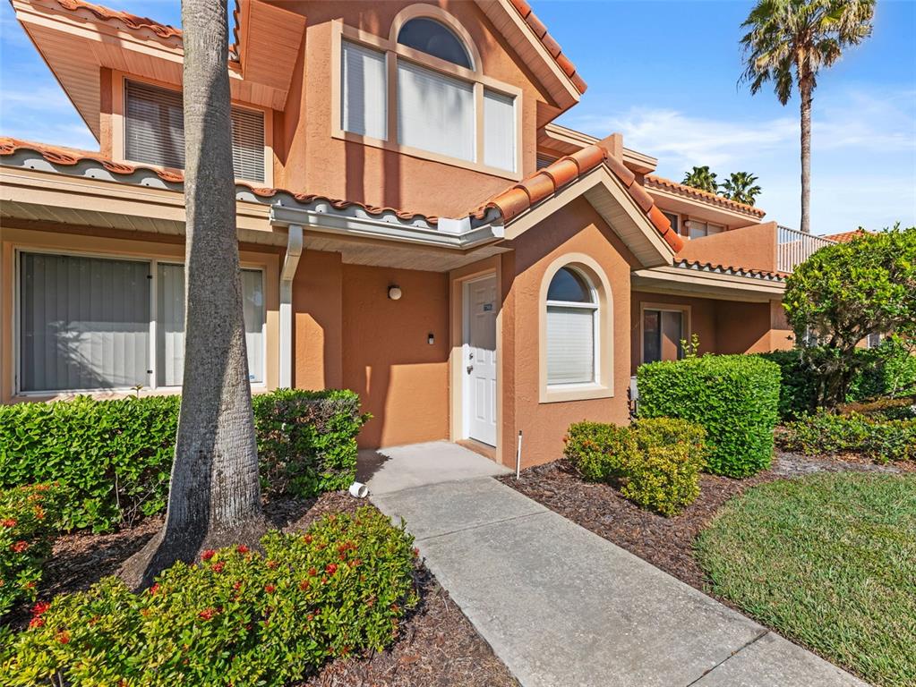 7705 Waterview Way, Unit 7705 Winter Haven, FL 33884 - Photo 5 of 33 a front view of a house with a yard and garage