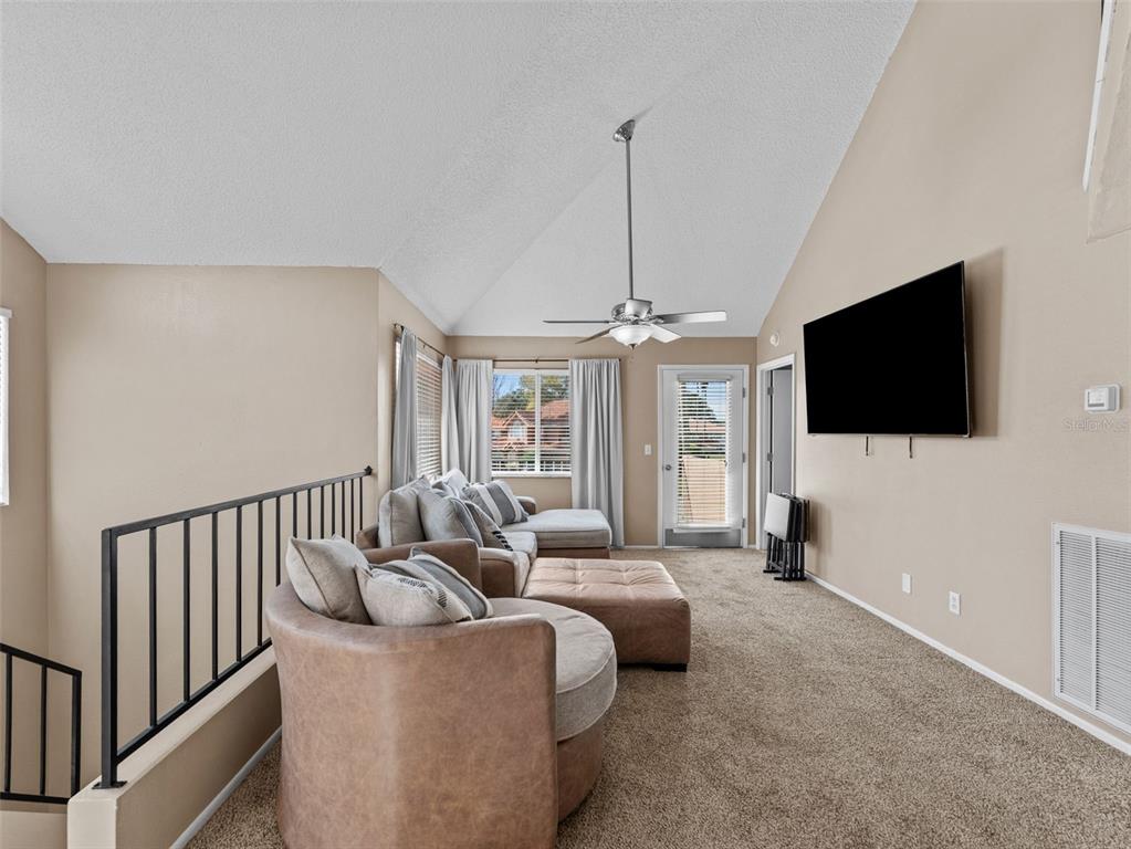 7705 Waterview Way, Unit 7705 Winter Haven, FL 33884 - Photo 6 of 33 a living room with furniture and a flat screen tv