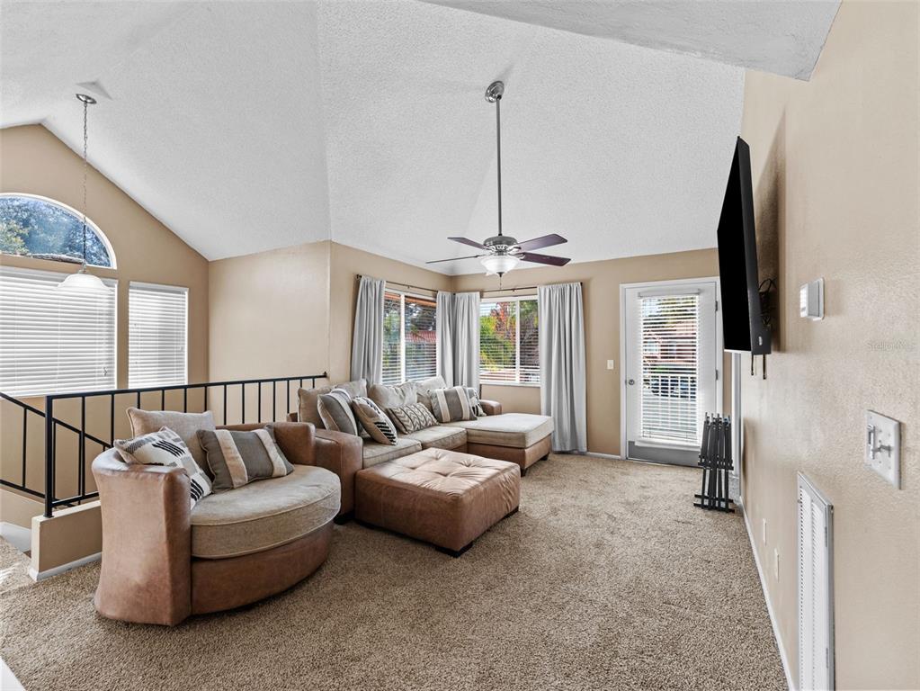 7705 Waterview Way, Unit 7705 Winter Haven, FL 33884 - Photo 7 of 33 a living room with furniture and a chandelier