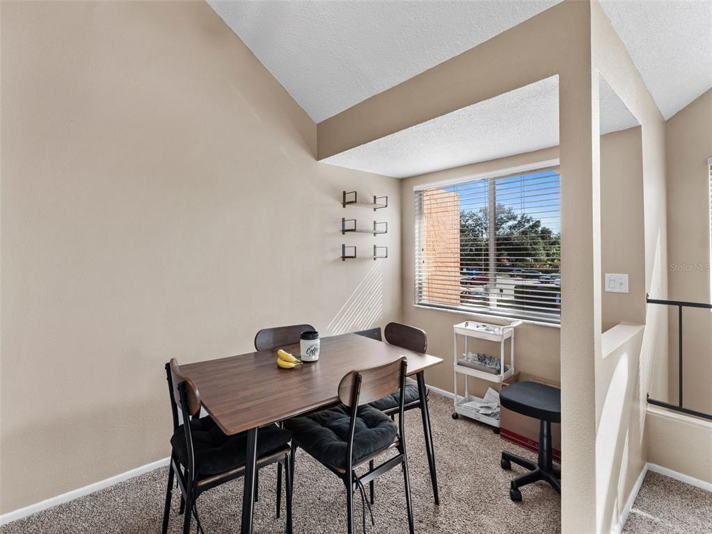 7705 Waterview Way, Unit 7705 Winter Haven, FL 33884 - Photo 9 of 33 a view of a workspace with furniture and a window