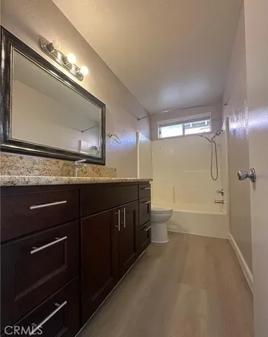 a bathroom with a sink a toilet a mirror and shower