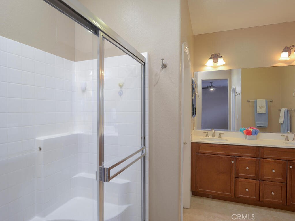 128 Lopez Way Hemet, CA 92545 - Photo 11 of 36 a spacious bathroom with a double vanity sink a mirror and a shower