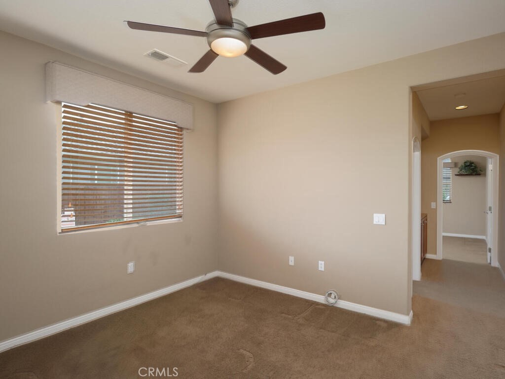 128 Lopez Way Hemet, CA 92545 - Photo 12 of 36 an empty room with a window and a fan