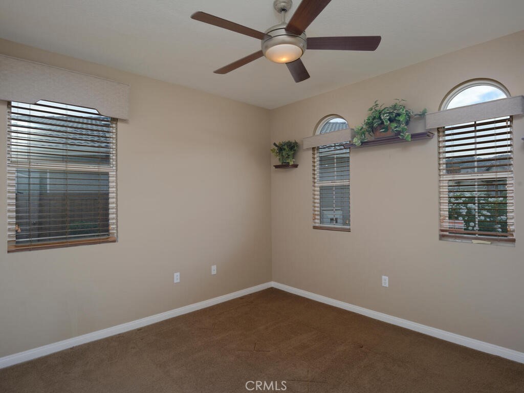 128 Lopez Way Hemet, CA 92545 - Photo 14 of 36 en empty room with windows and ceiling fan