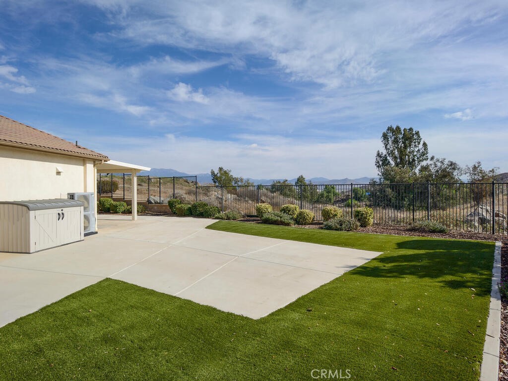 128 Lopez Way Hemet, CA 92545 - Photo 23 of 36 a view of a house with a yard and a large tree