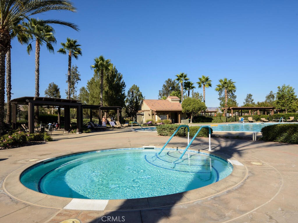 128 Lopez Way Hemet, CA 92545 - Photo 31 of 36 a view of a swimming pool with lawn chairs and plants