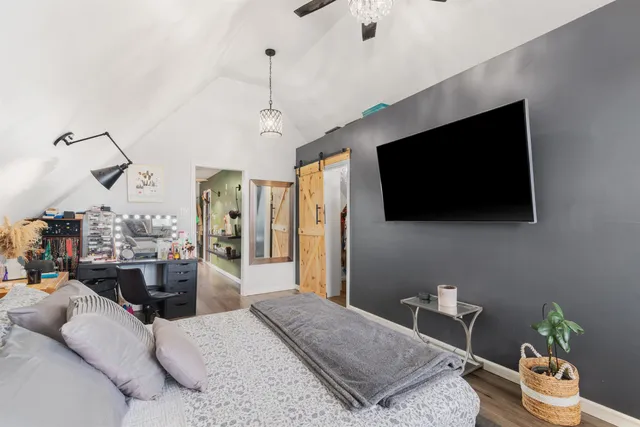 a bedroom with a bed and a flat screen tv