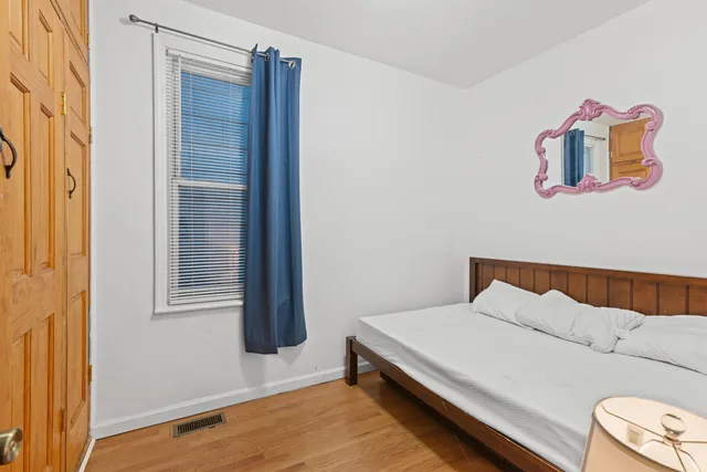 a bedroom with a bed and a window