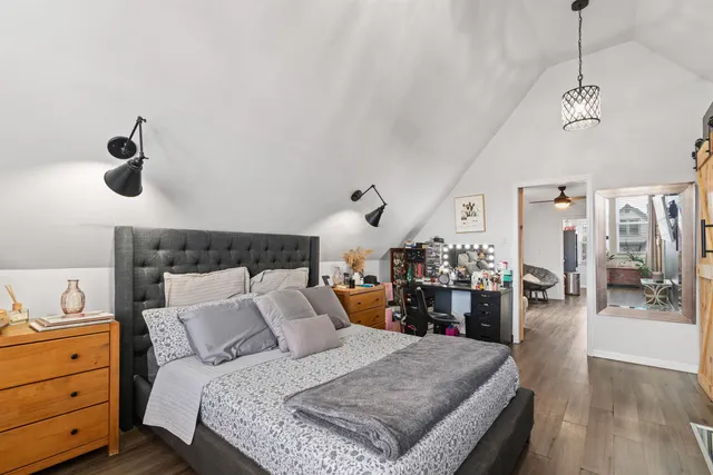 a bed room with a bed and a mirror