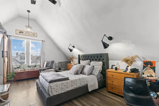 a bedroom with furniture and a large window