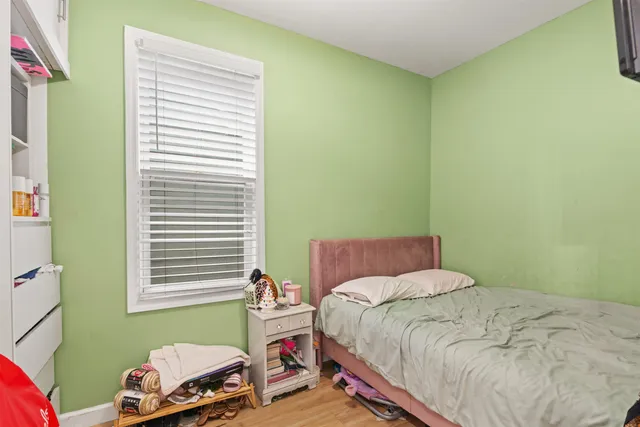 a bedroom with a bed and windows