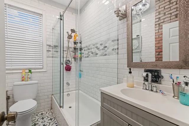 a bathroom with a sink a toilet and shower