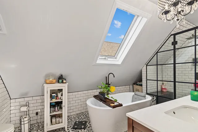 a bathroom with a sink mirror and vanity