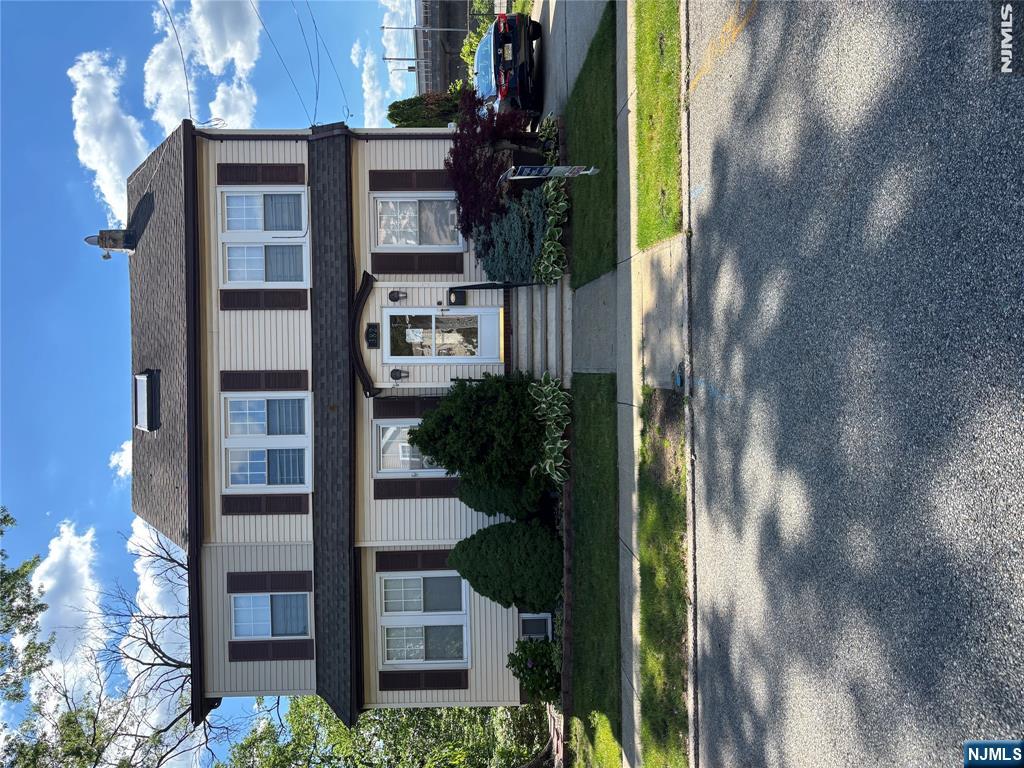 382 Riverside Avenue Rutherford, NJ 07070 - Photo 1 of 29 a front view of a house with a yard