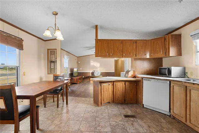 a kitchen with furniture a center island and appliances