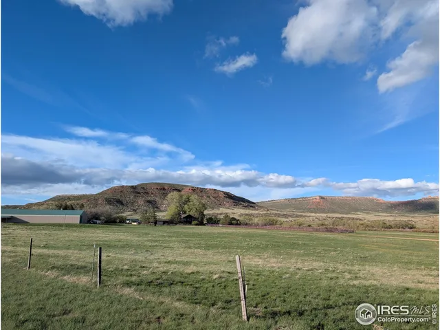 a view of a green field with an trees