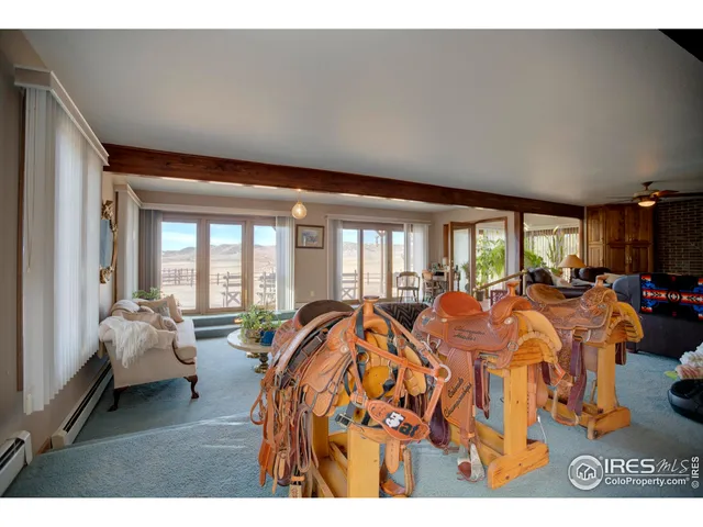 a living room with lots of furniture and a large window