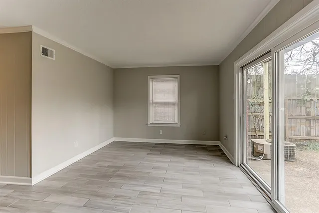 a view of an empty room with glass door