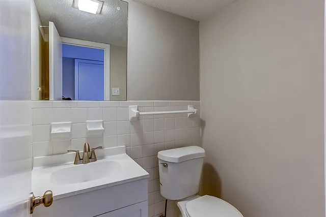 a bathroom with a sink a toilet and mirror