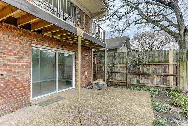 a view of a backyard with wooden fence