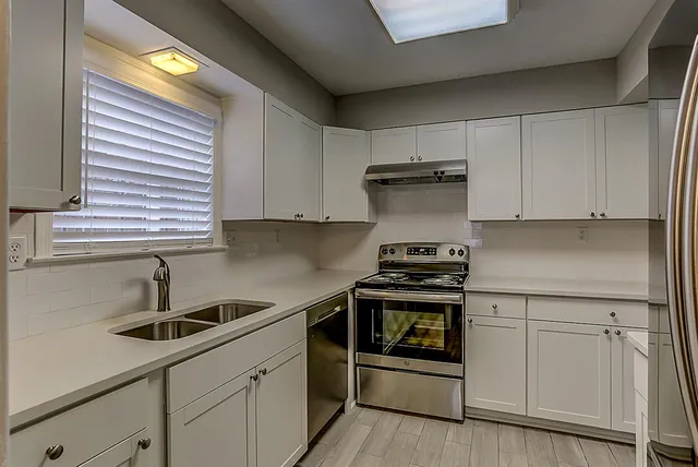 a kitchen with a sink and cabinets