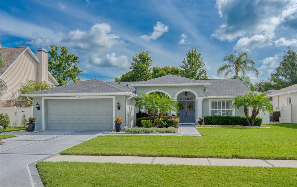 7828 Primula Lane New Port Richey, FL 34654 - Photo 1 of 1 a front view of a house with a garden and plants